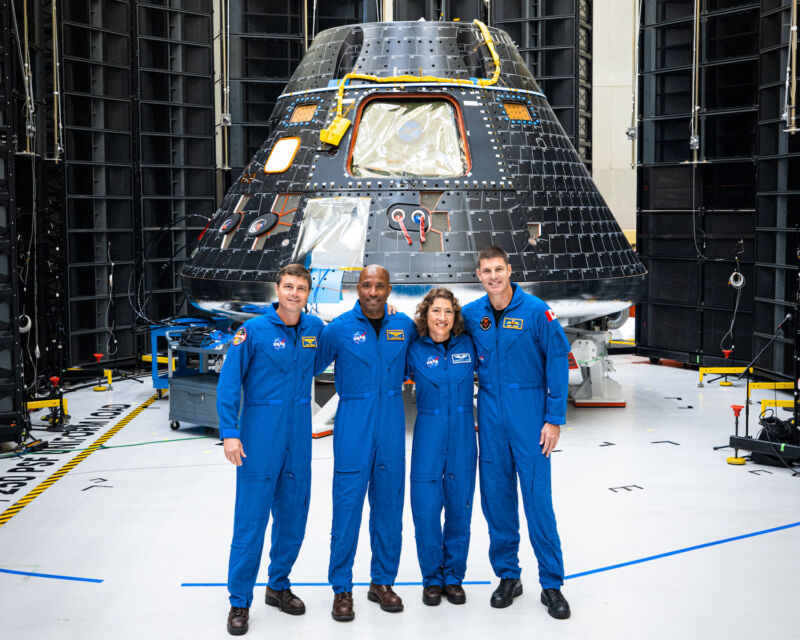 Artemis II crew in front of Orion spacecraft