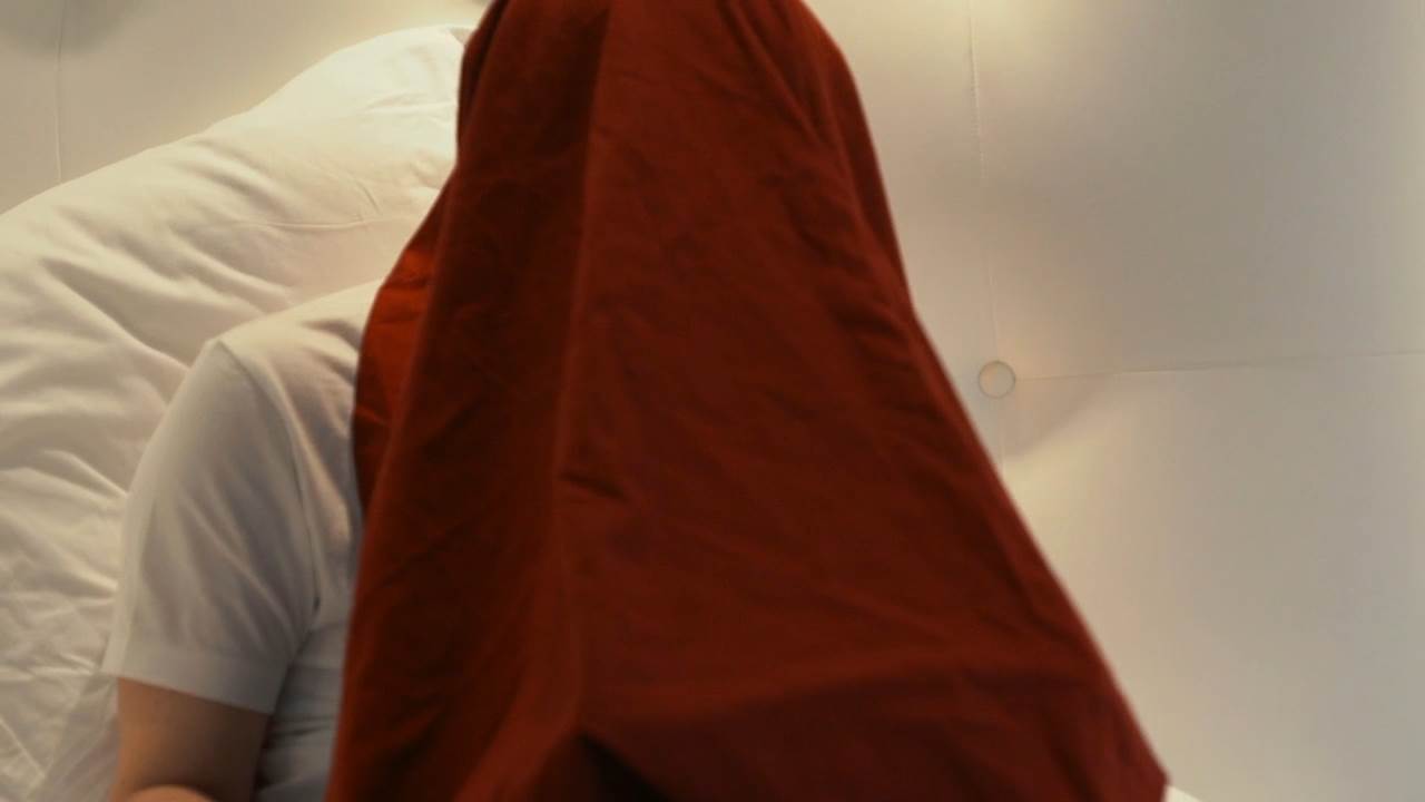 Edward Snowden entering his password under the blanket